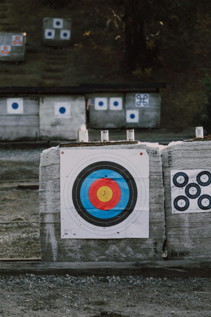 Close-up of archery targets with colorful bullseye in an outdoor range setting.
